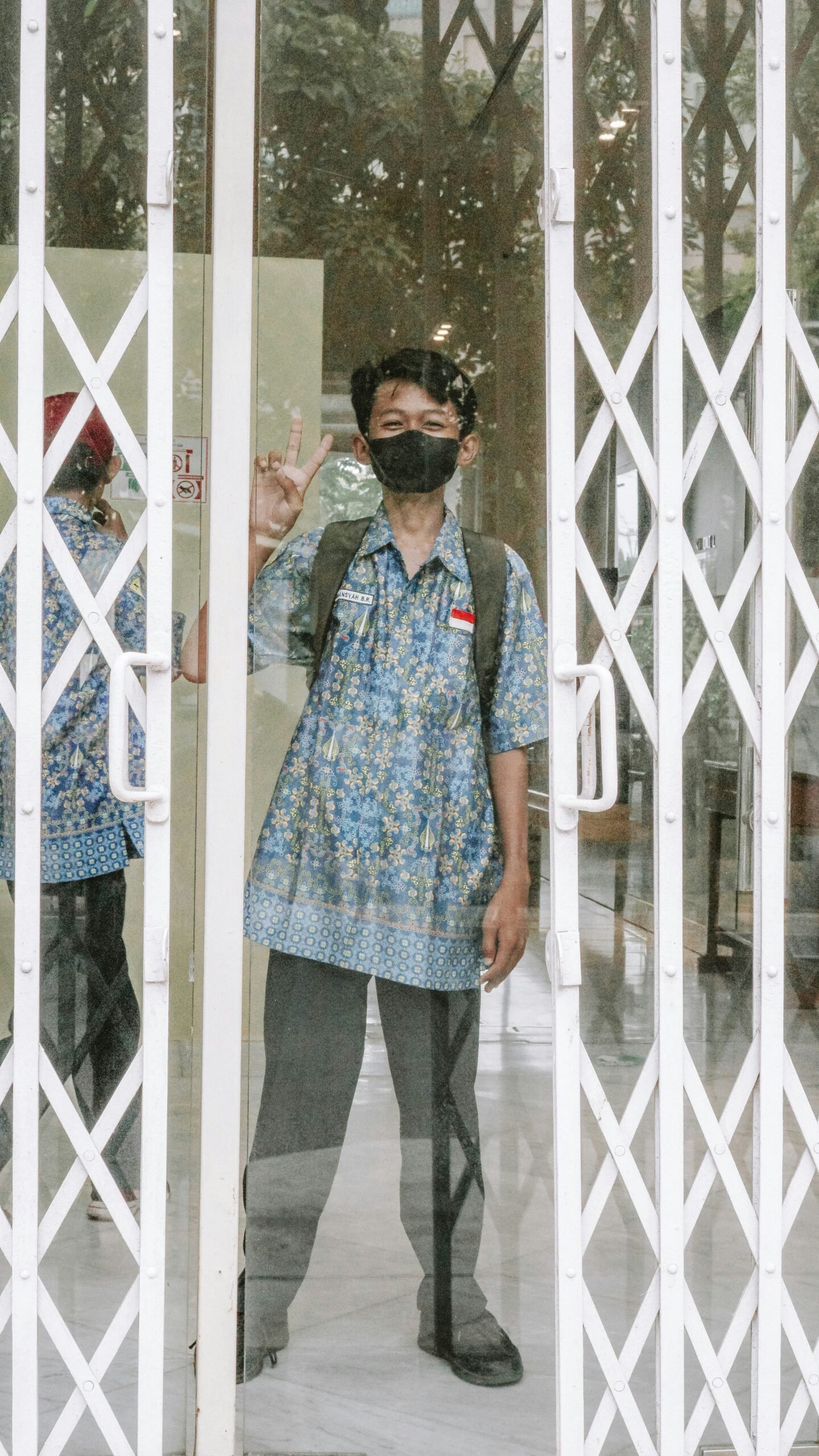 a man standing in front of a glass door